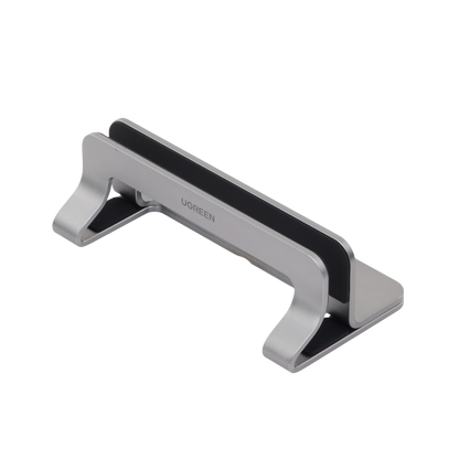 Soporte Vertical para Laptop / Adecuado para escritorio / Anchura Ajustable (12-26mm) / Amplia compatibilidad / Anti-Arañazos / Anti-Deslizante /Ajustable Mediante Tornillos / Color Plata / Aluminio + Silicona